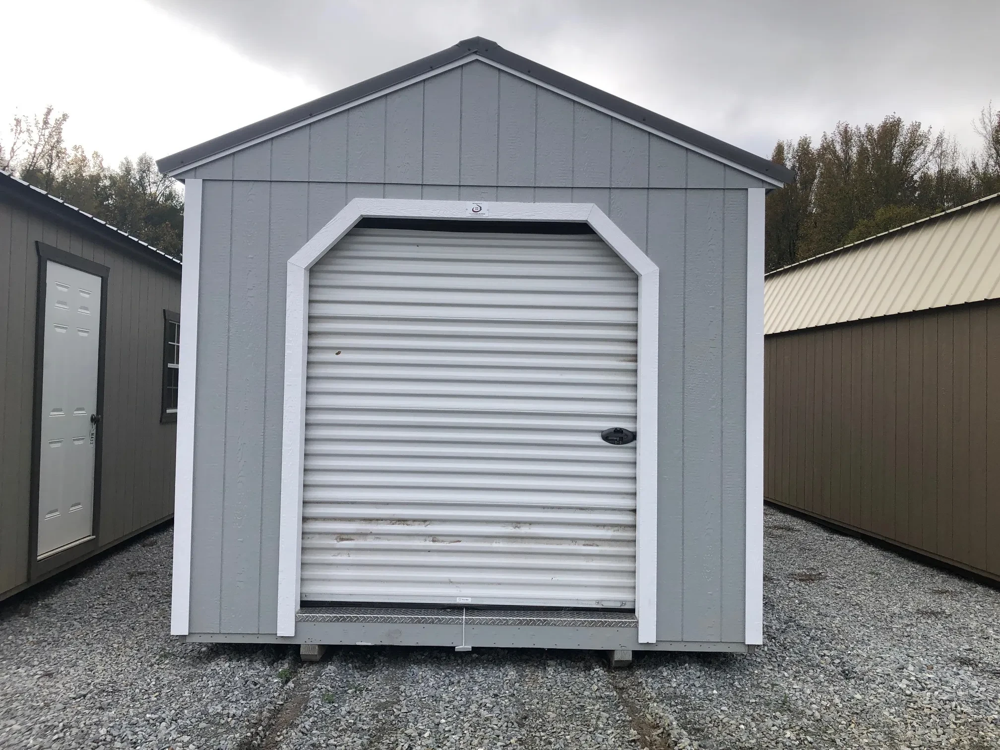 a gray utility garage with a 6x7 rollup door closed