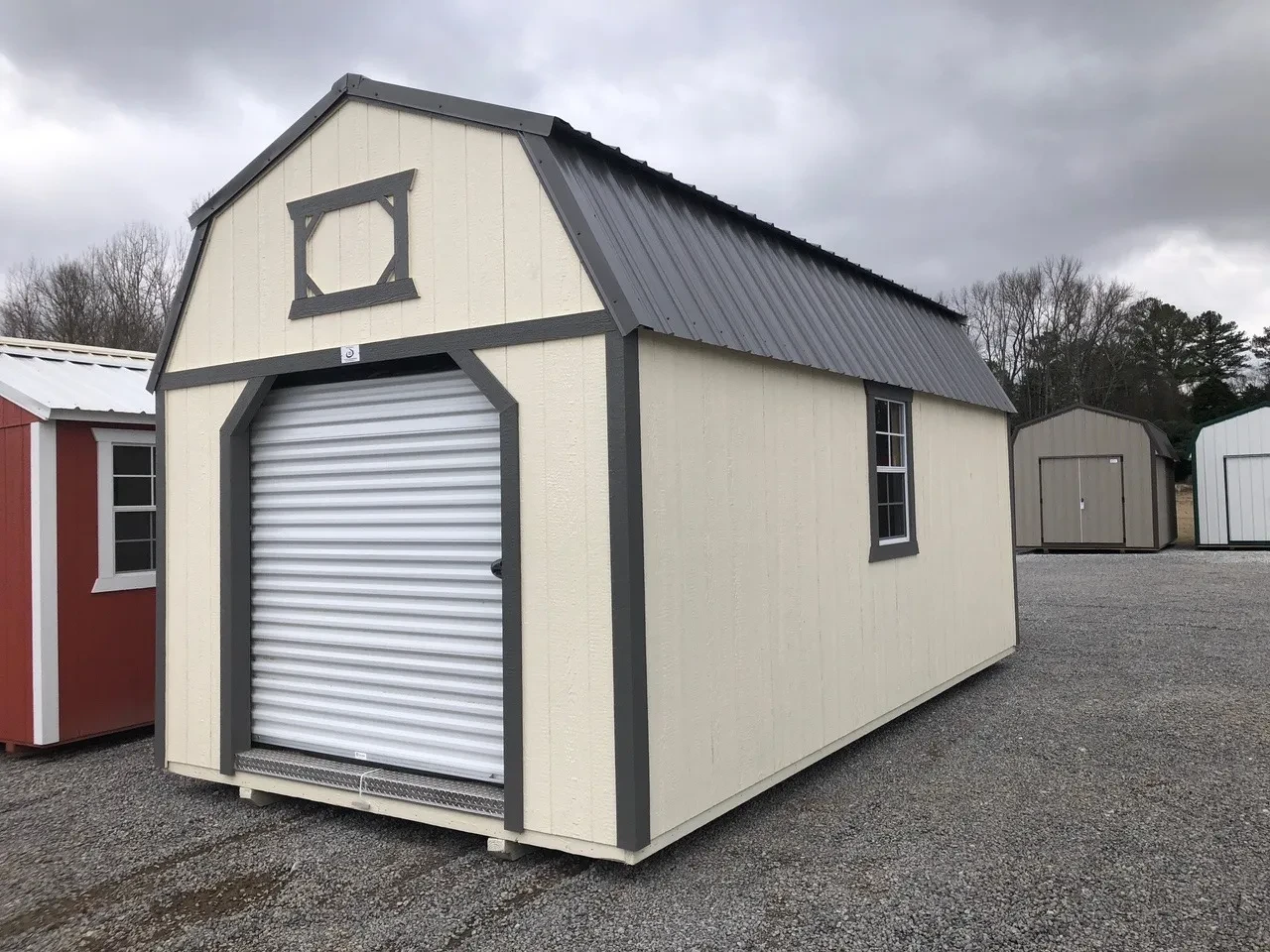 a wood lofted garage with a window on the right wall and a 6x7 rollup door closed and decorative loft trim