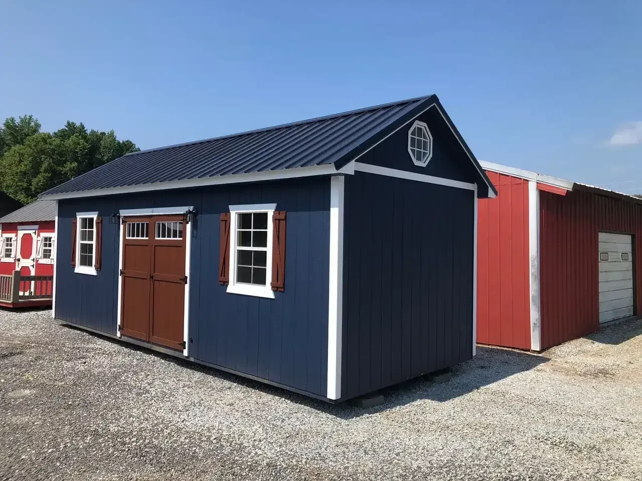 a large dark blue garden shed with a roof overhand, double doors, and multiple windows