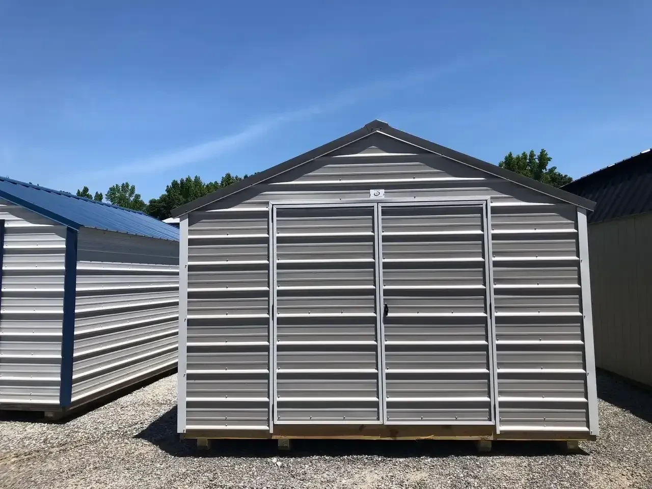 a gray metal utility shed with 72" double doors and horizontal metal on the walls and doors