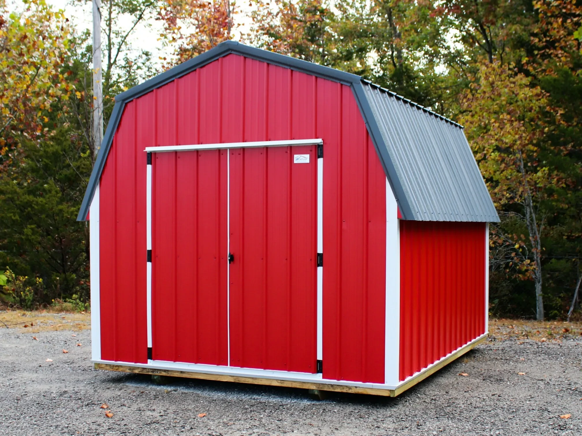 a little red metal shed with double doors