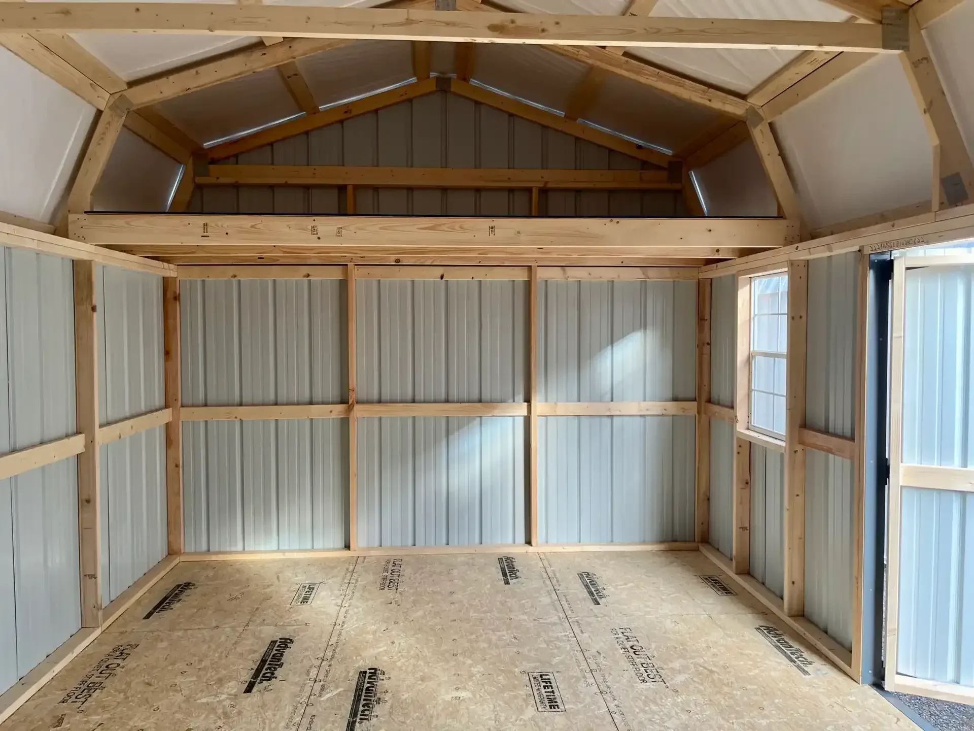 inside a metal side lofted barn which has a loft and a window