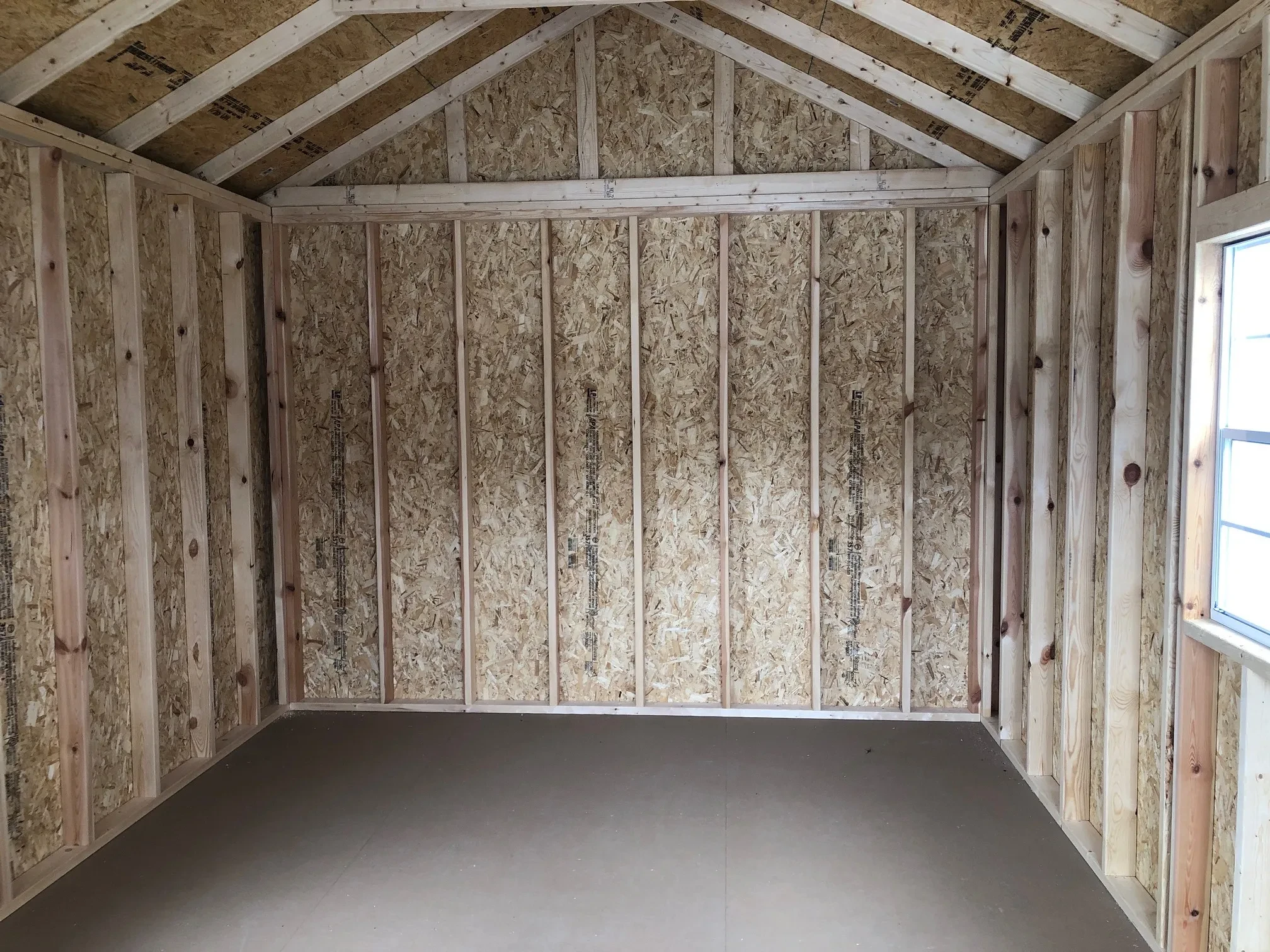 the inside of a wood cabin looking at the back wall