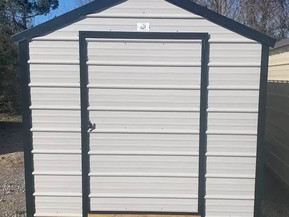 a gray metal shed with a single metal door and horizontal metal on the door and walls
