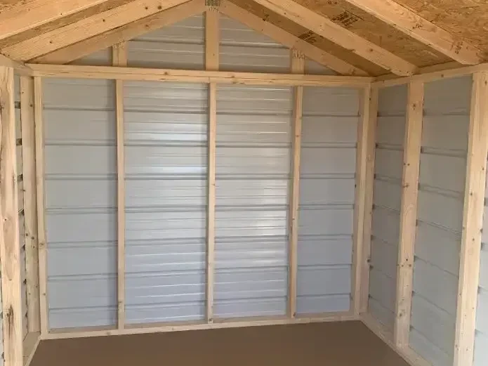 inside a metal utility shed looking at the framing and interior metal