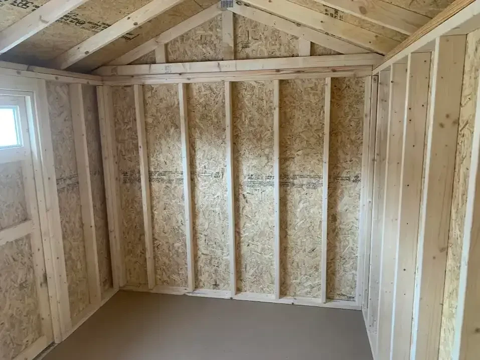 inside a small wood garden shed with a solid floor