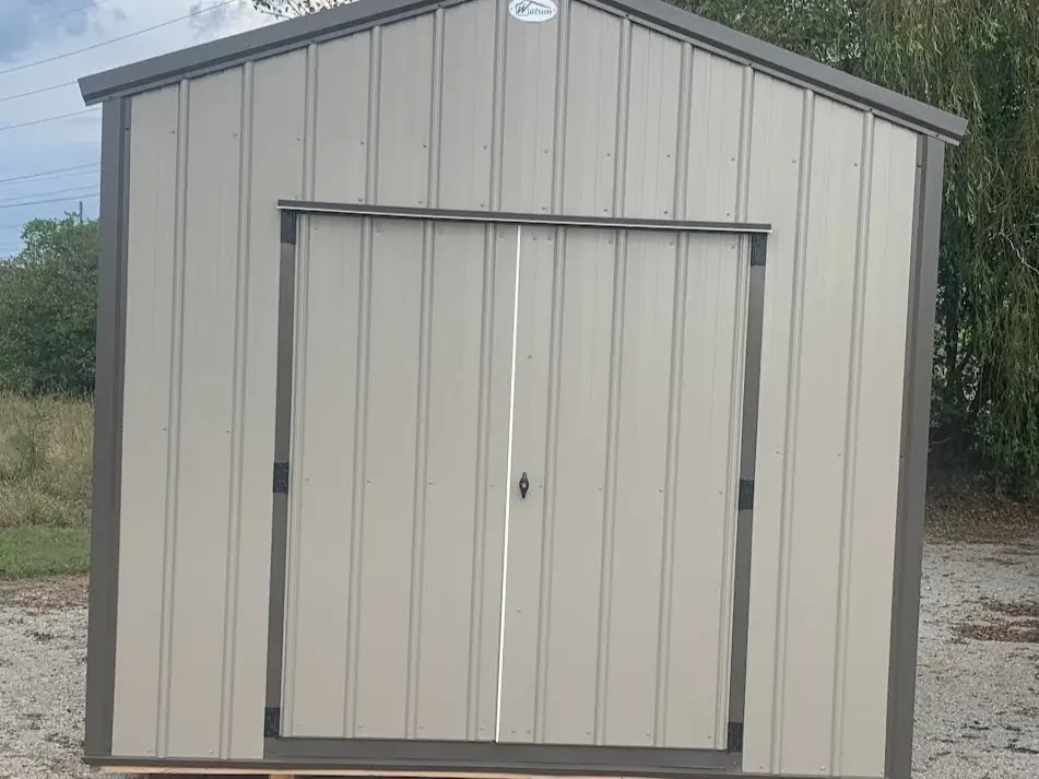 a clay colored metal shed with double doors and vertical metal on the doors and walls