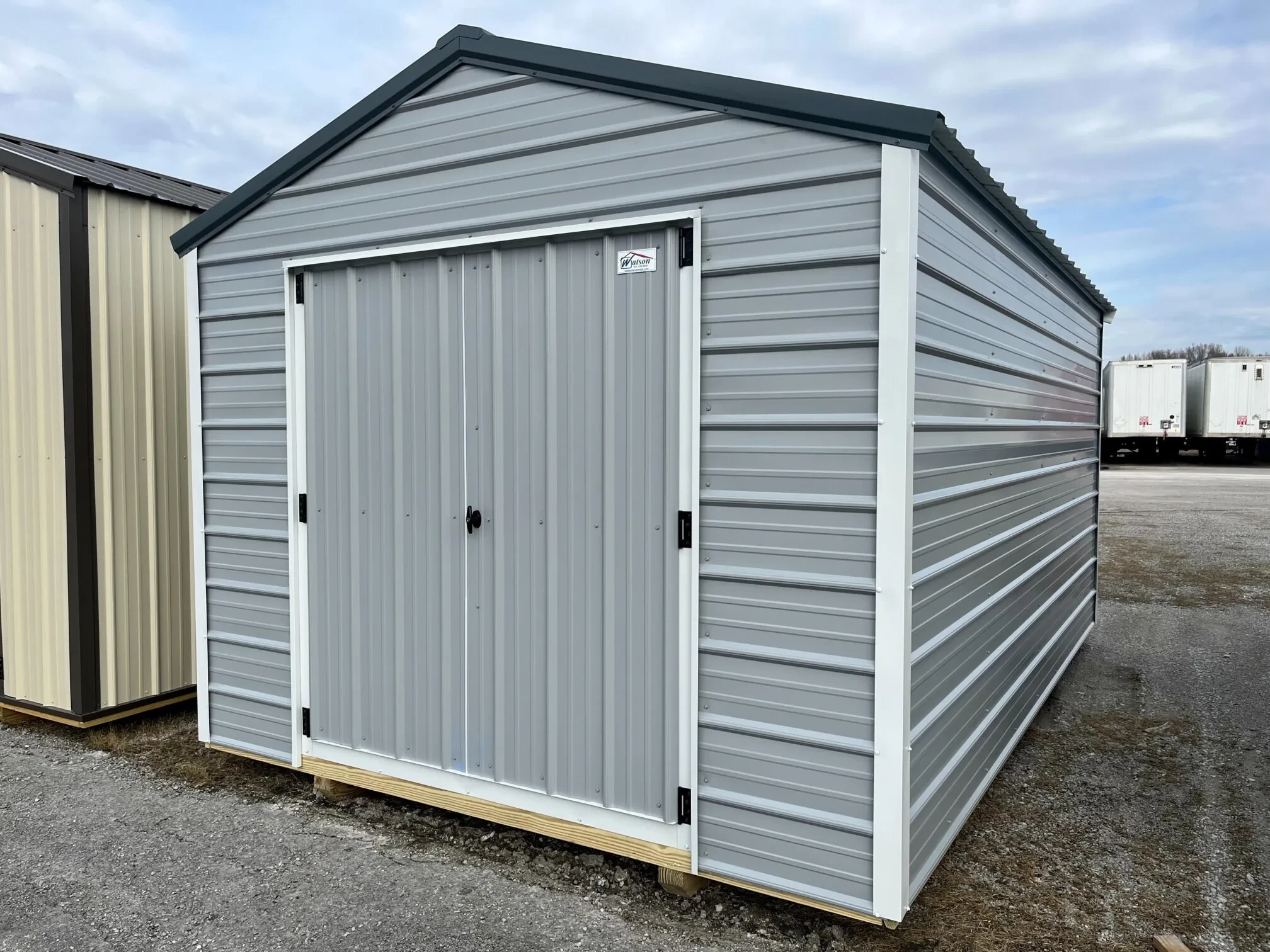 a light gray economy metal shed with double doors