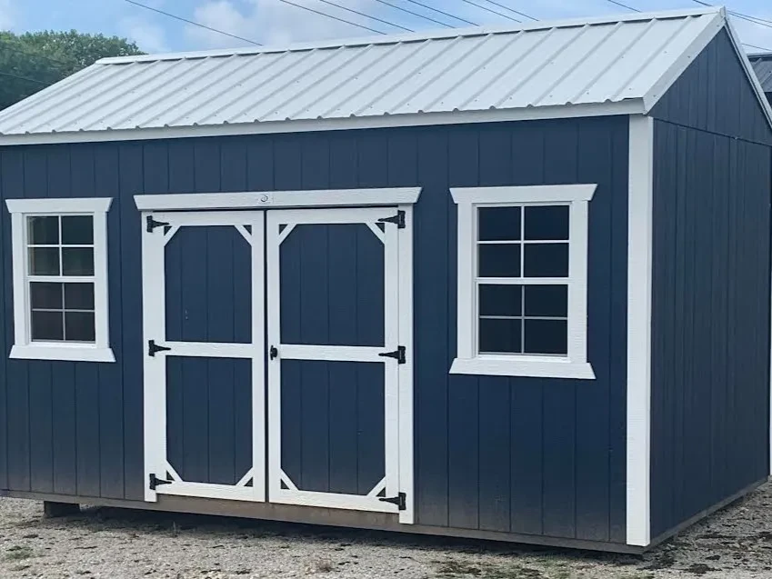 a blue garden shed with white trim, double doors, and two 24"x36" windows and a white metal roof