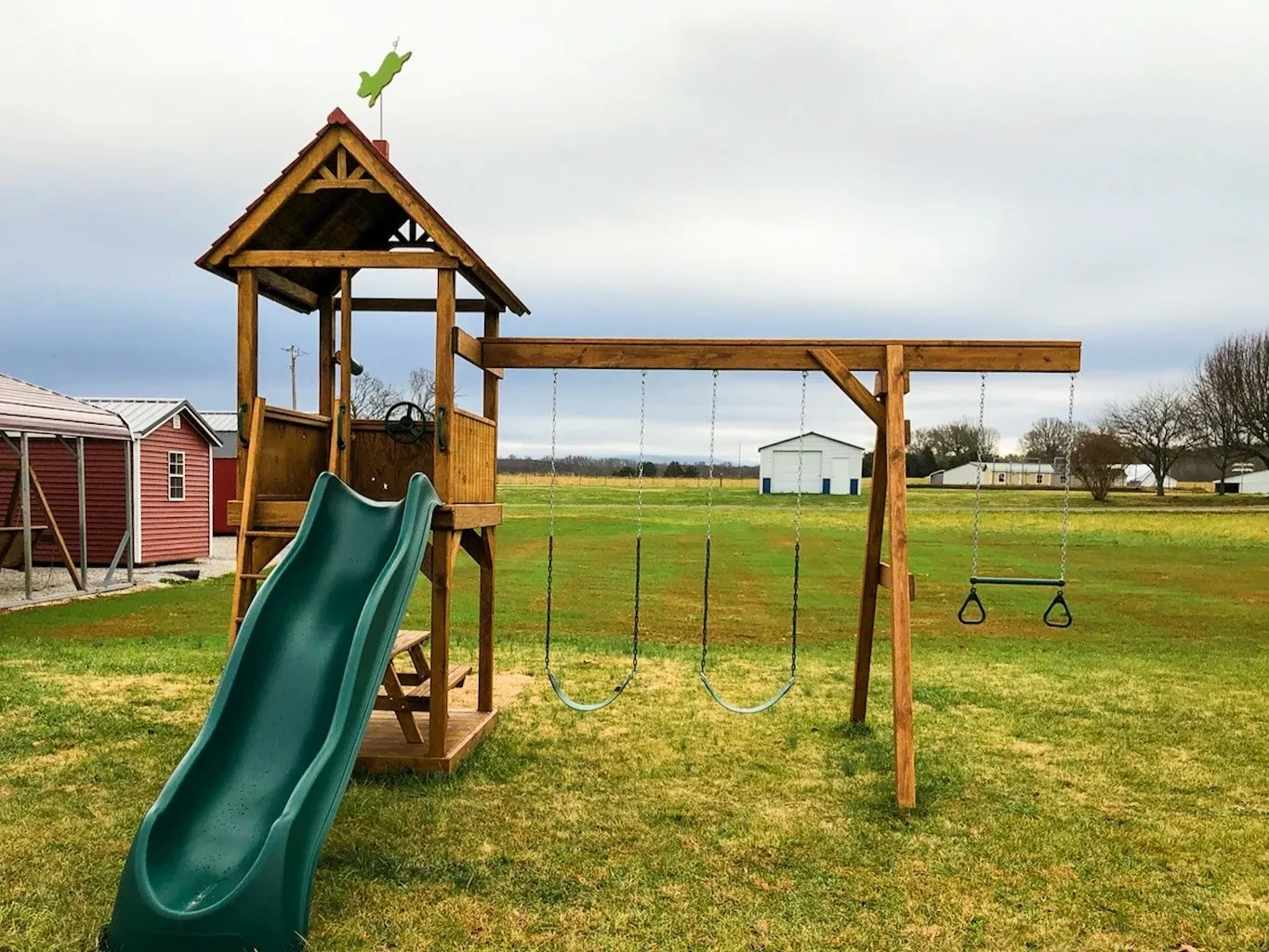 a stained wood picnic tower playset