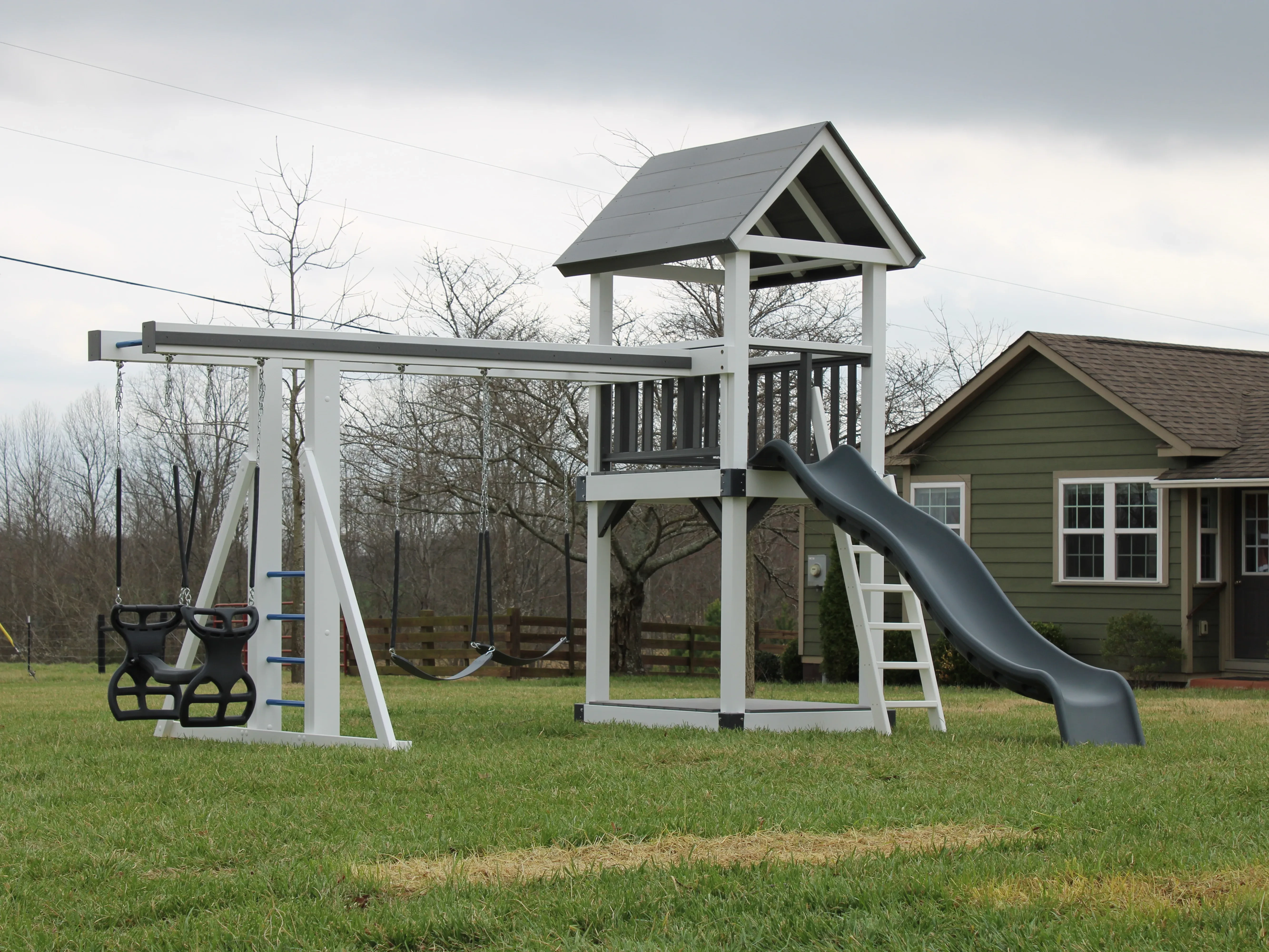 a white vinyl sandbox tower playset