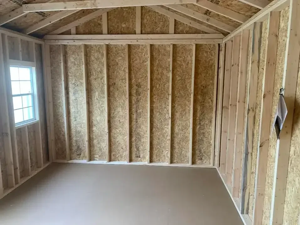 the left side of the interior of a garden shed showing the wall and the floor