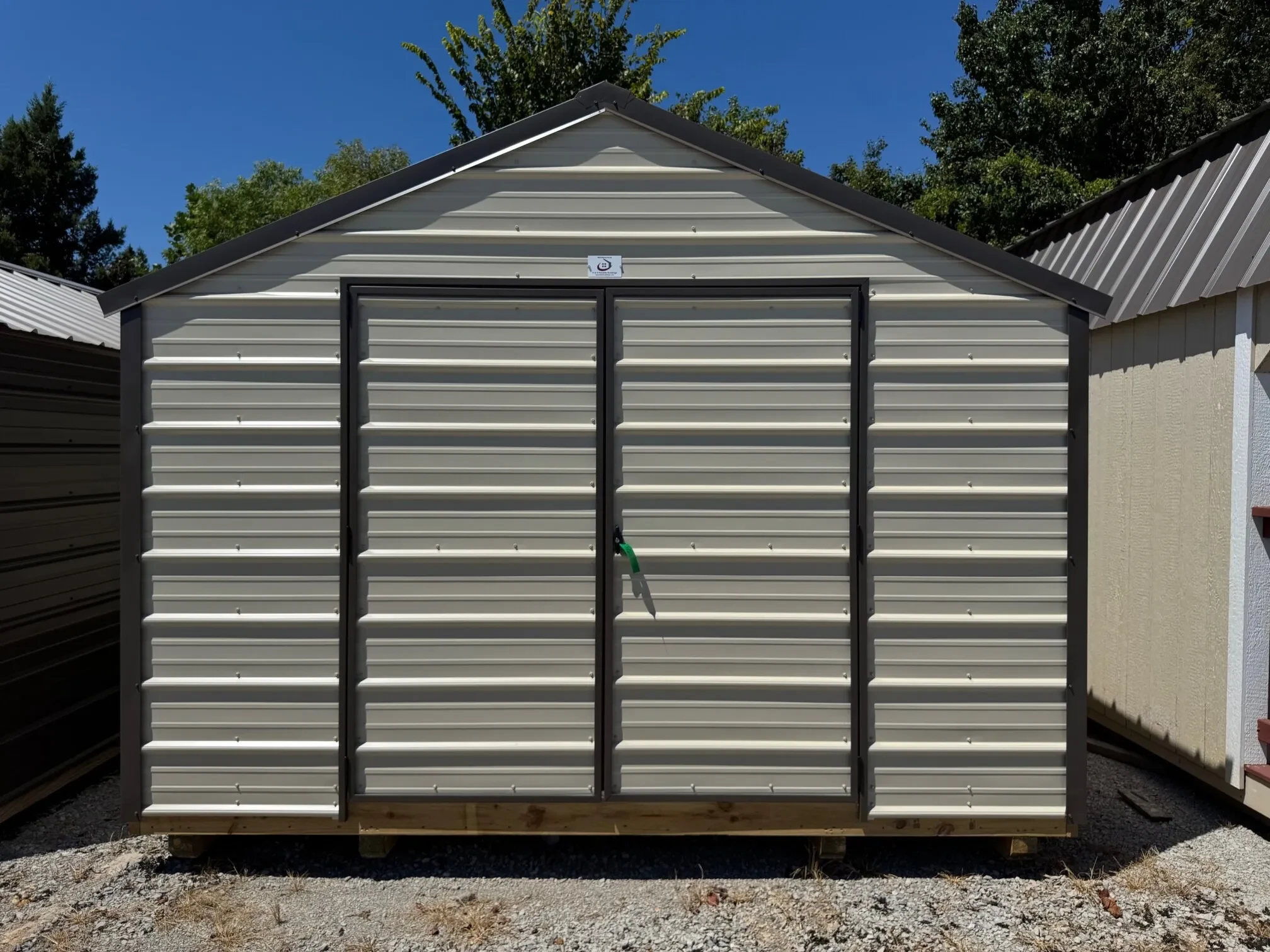 the front of a metal shed with double doors