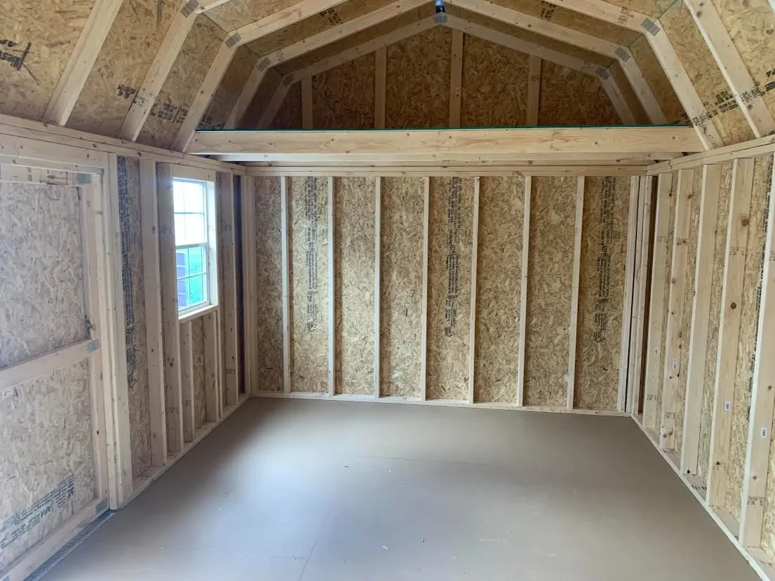 inside a side lofted barn looking at the left wall, it has a 4' loft above a window on the front wall