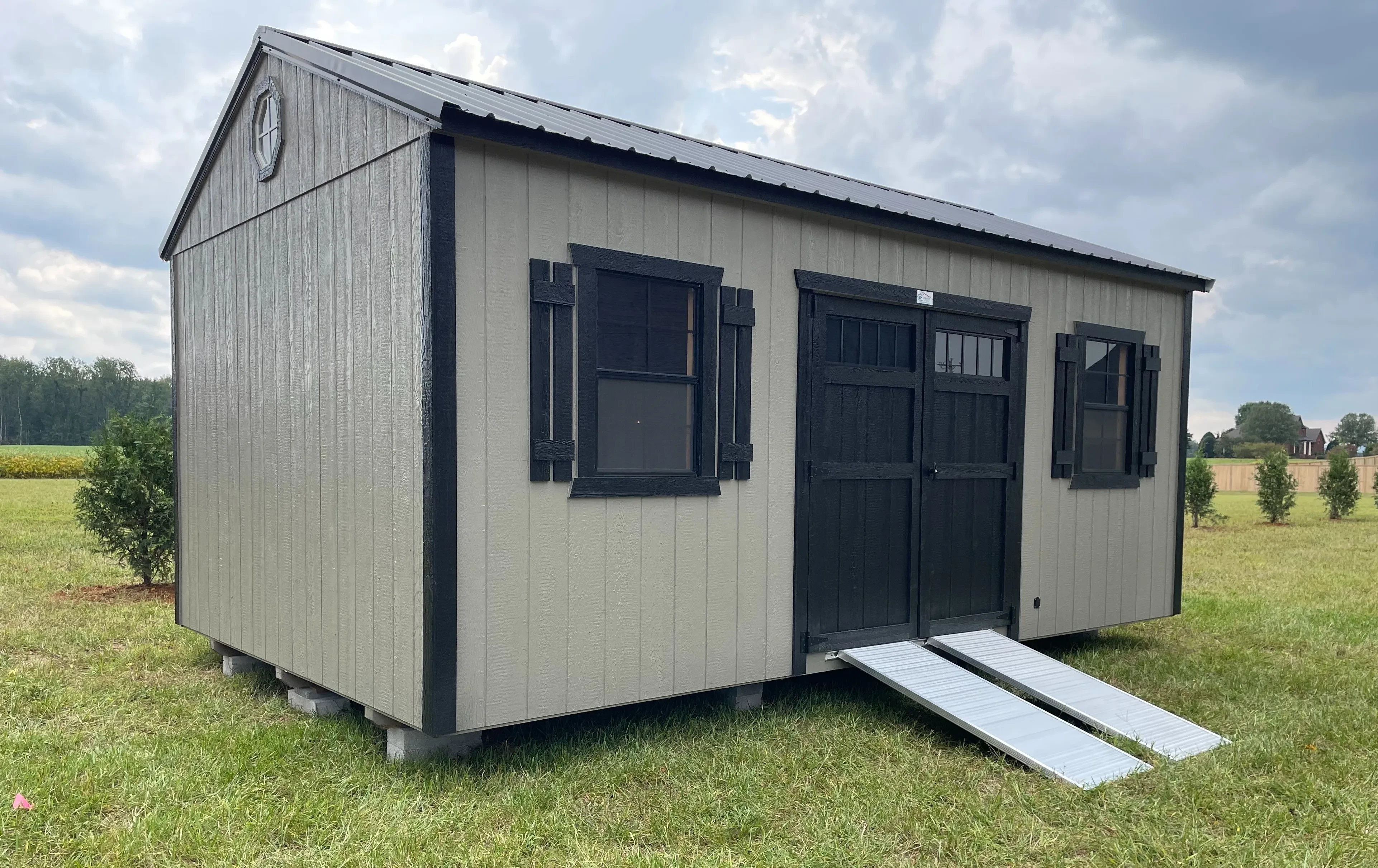 Clay and Black shed set up in the yard.