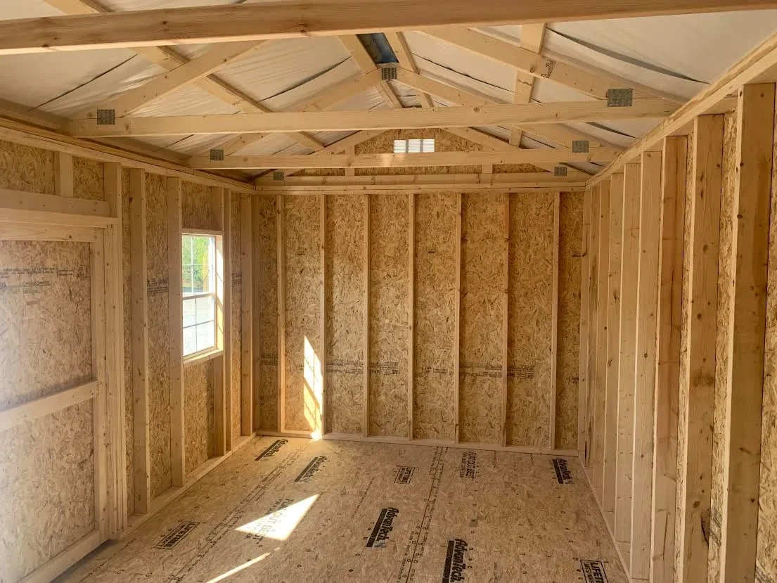 inside a wood garden shed looking at the left wall, and you can see a window in the front wall