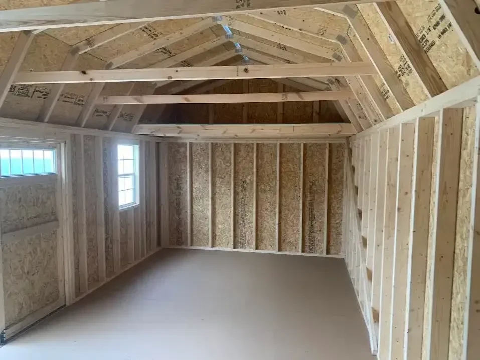 the interior of a large side lofted barn looking at the left wall which has a 4' loft