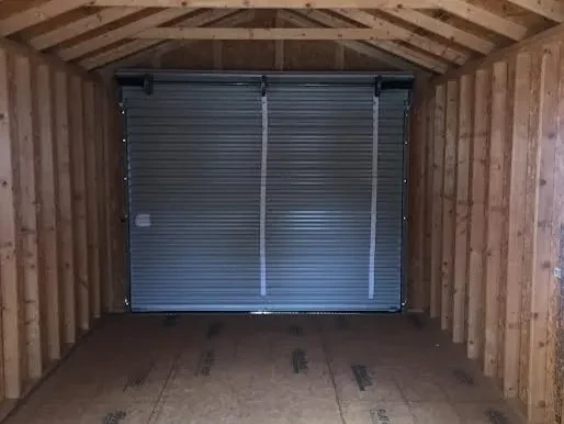 the back wall of a cabin which has a 9x7 rollup door closed