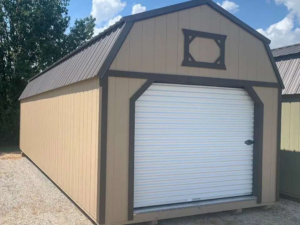a light brown lofted garage with an 8x7 rollup door closed and decorative loft trim above it