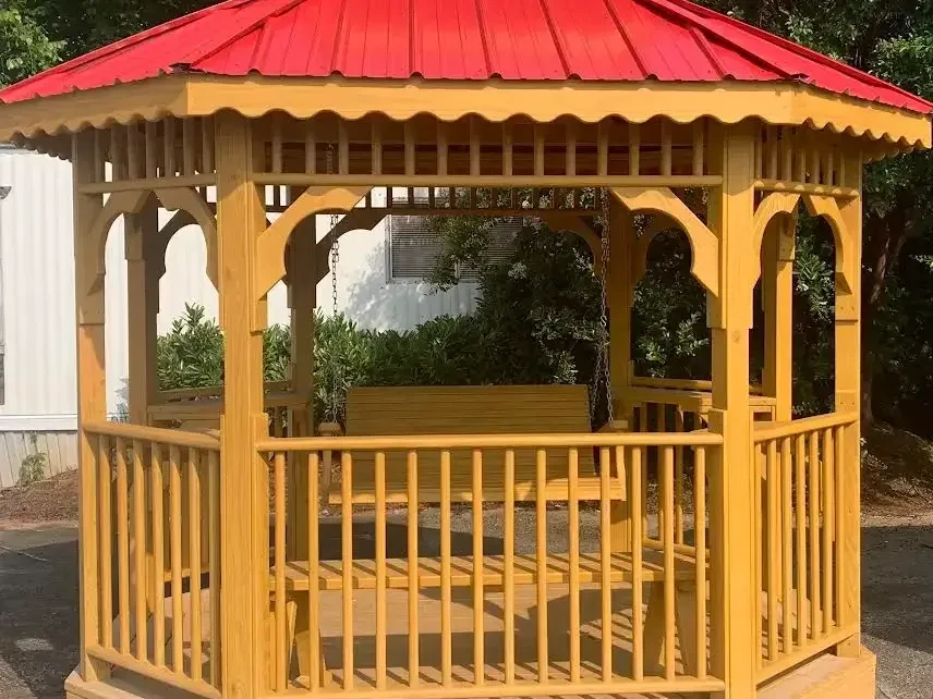 a honey gold stained and sealed teahouse with a red metal double roof