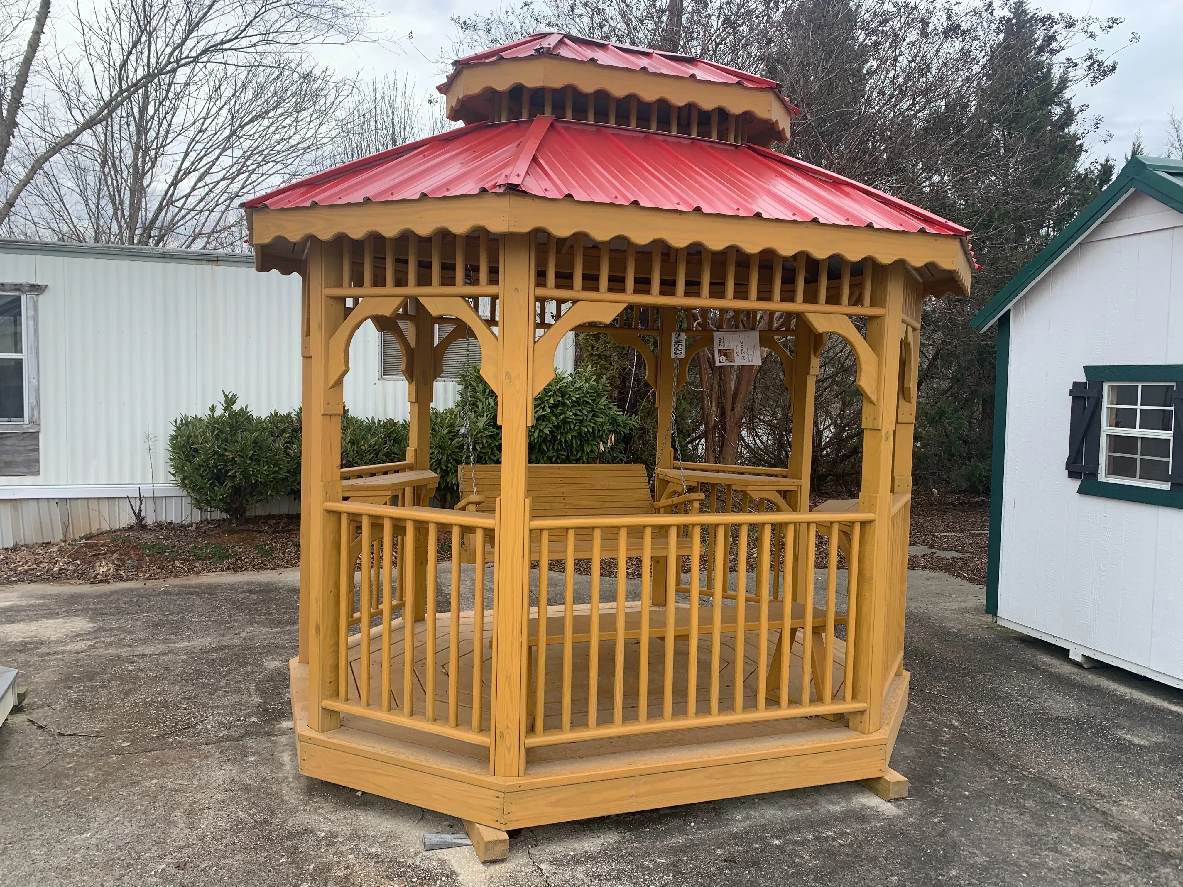 a honey gold stained and sealed teahouse with posts and rails. It has an opening to walk through