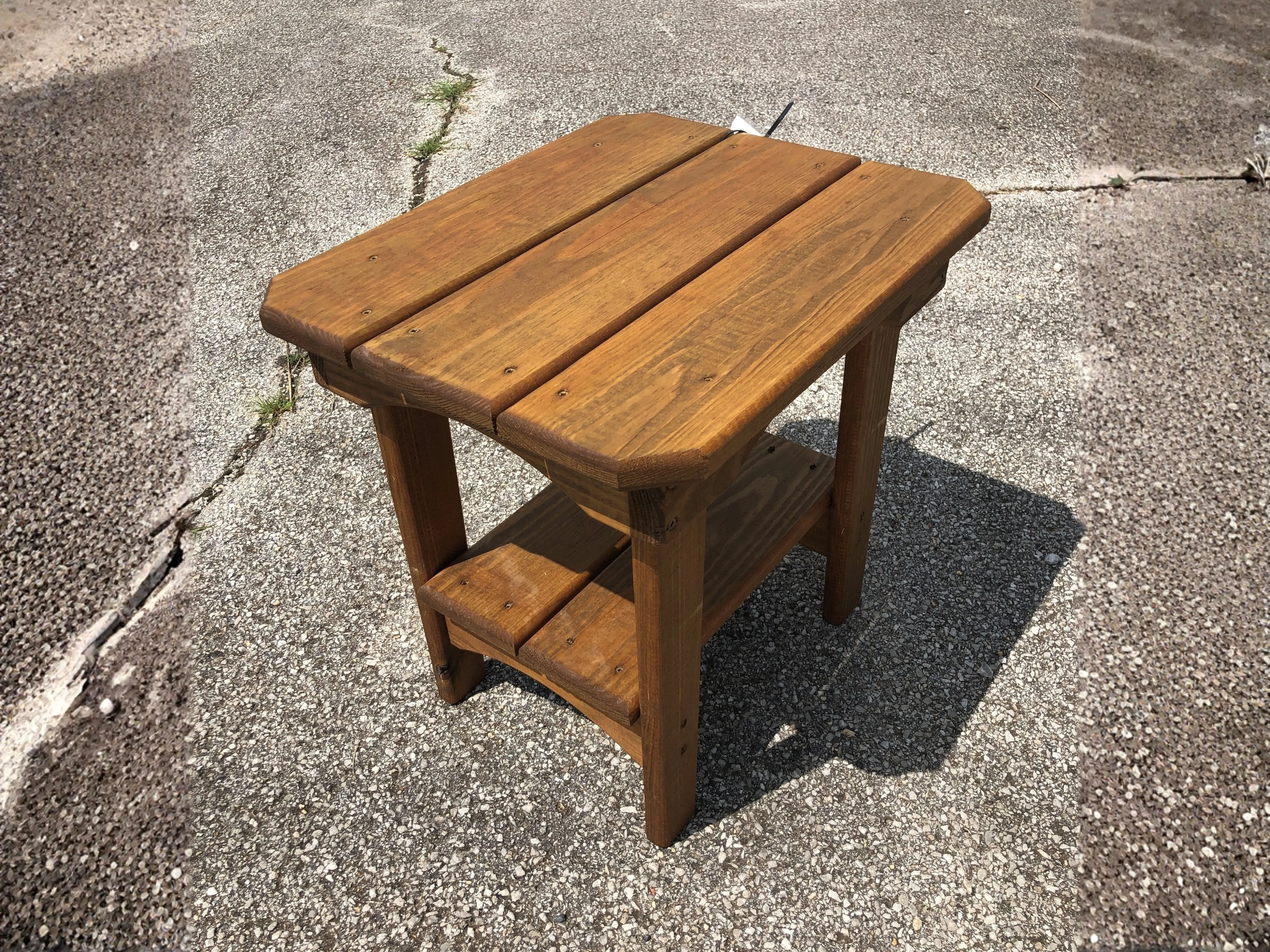Wood end table setting on pavement