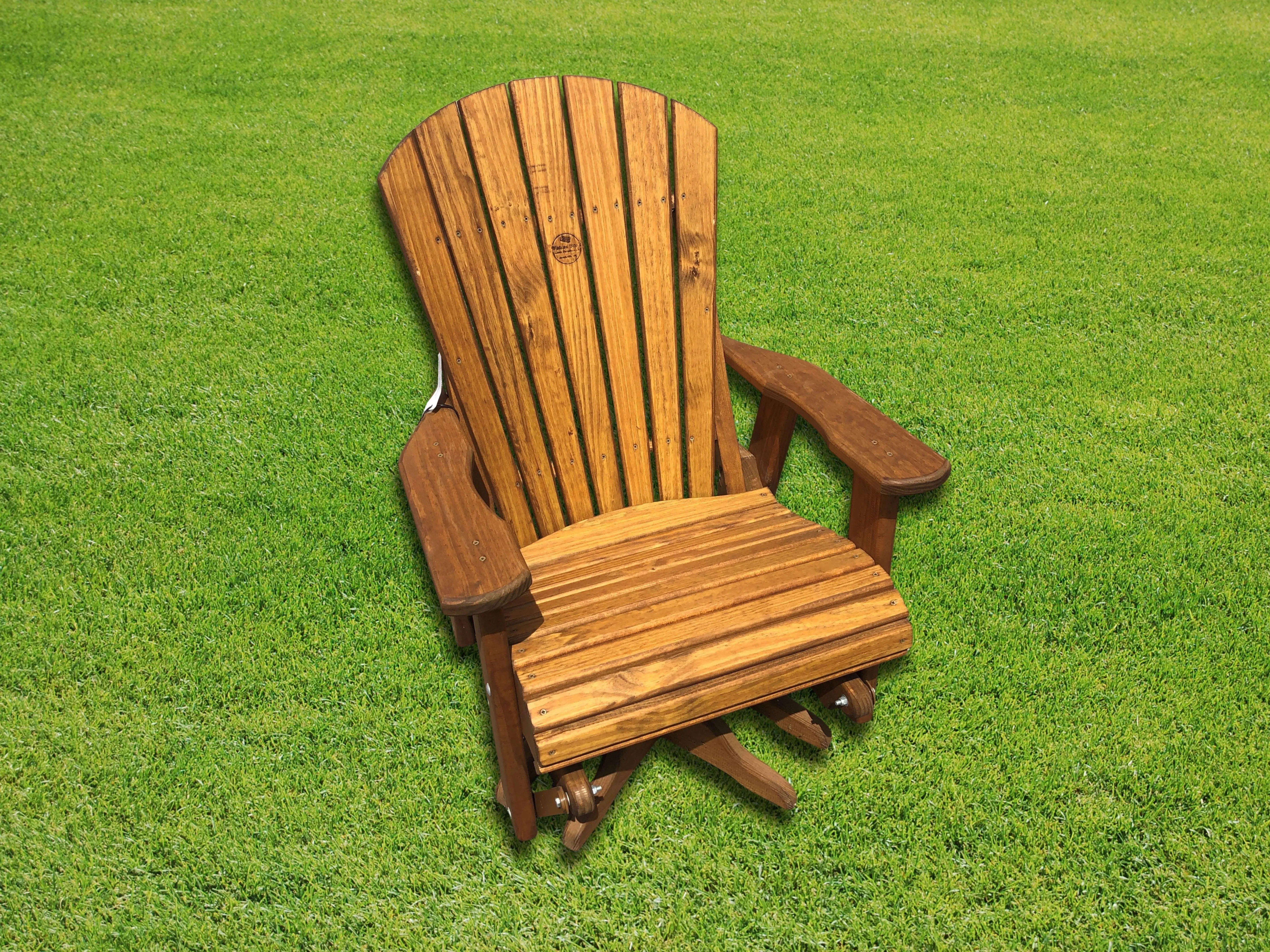 Wood single swivel glider sitting in the grass
