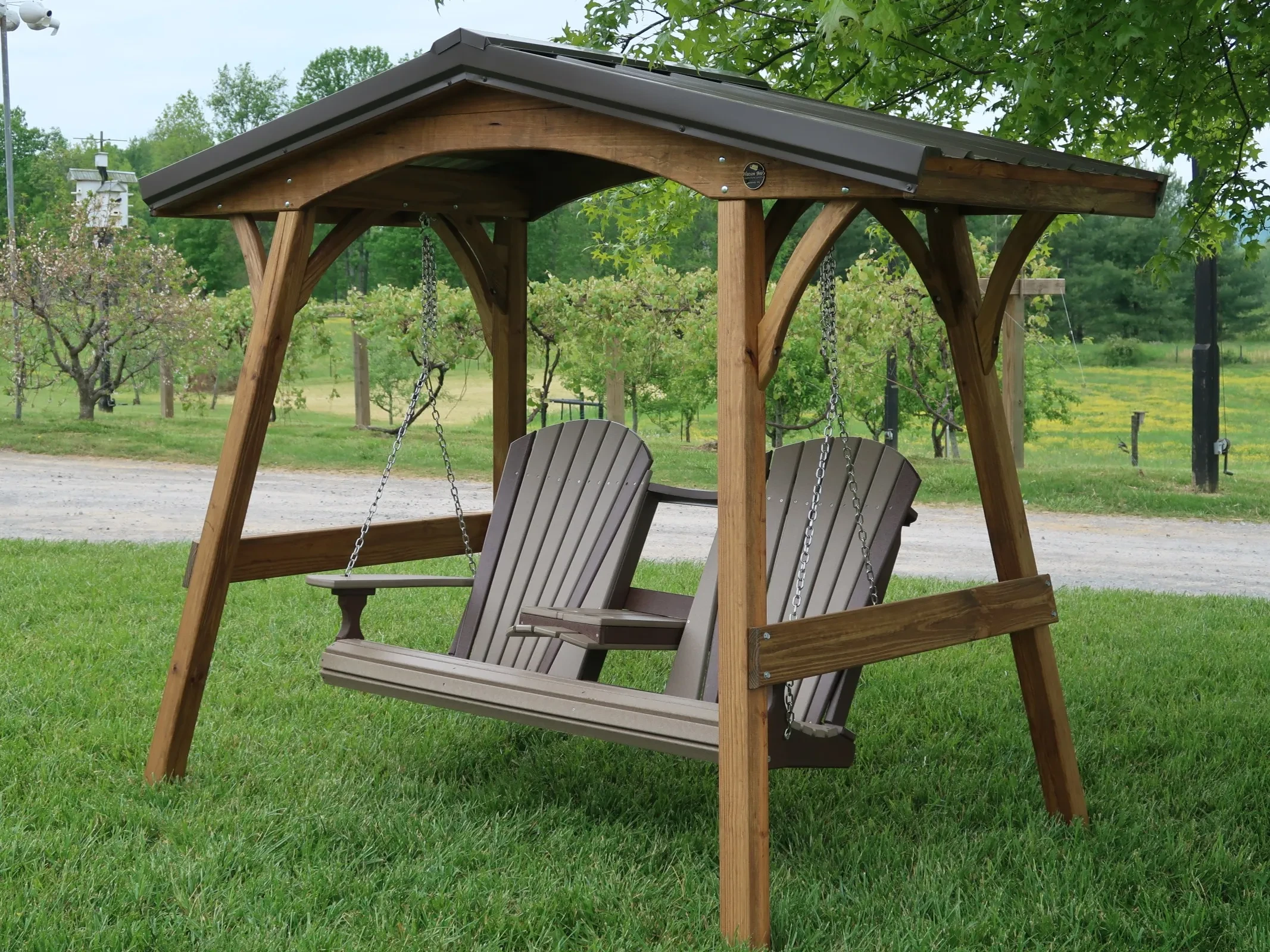 Wood Swing cover with swing setting in the grass.