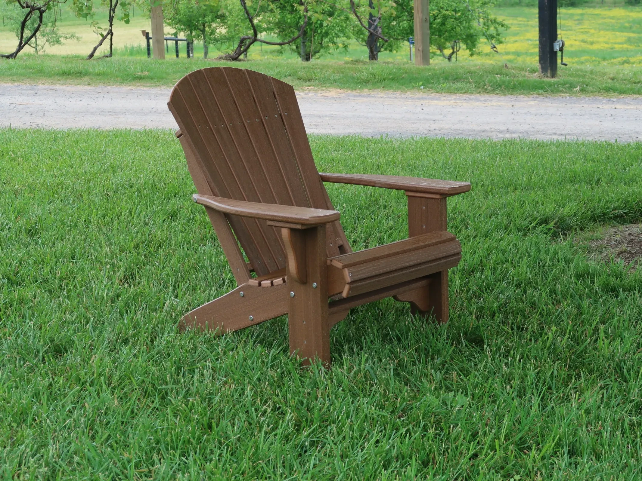 Adirondack polywood chair sitting in the grass